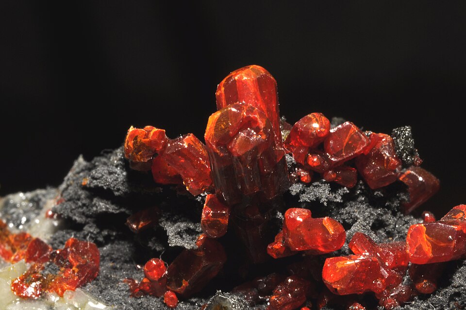 Deep red Realgar crystals, a toxic arsenic sulfide mineral.